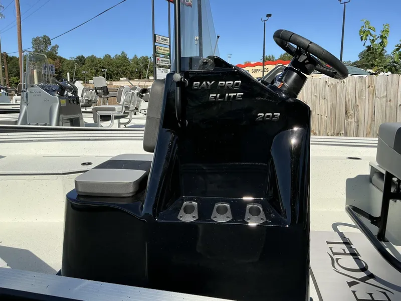 Slide: The Image of 2025 Excel Bay Pro 203 Elite boat console with steering wheel and seating. - 3