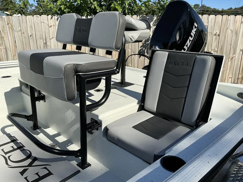 Slide: The Image of 2025 Excel Bay Pro 203 ELITE boat seats with Suzuki motor, outdoor setting. - 4