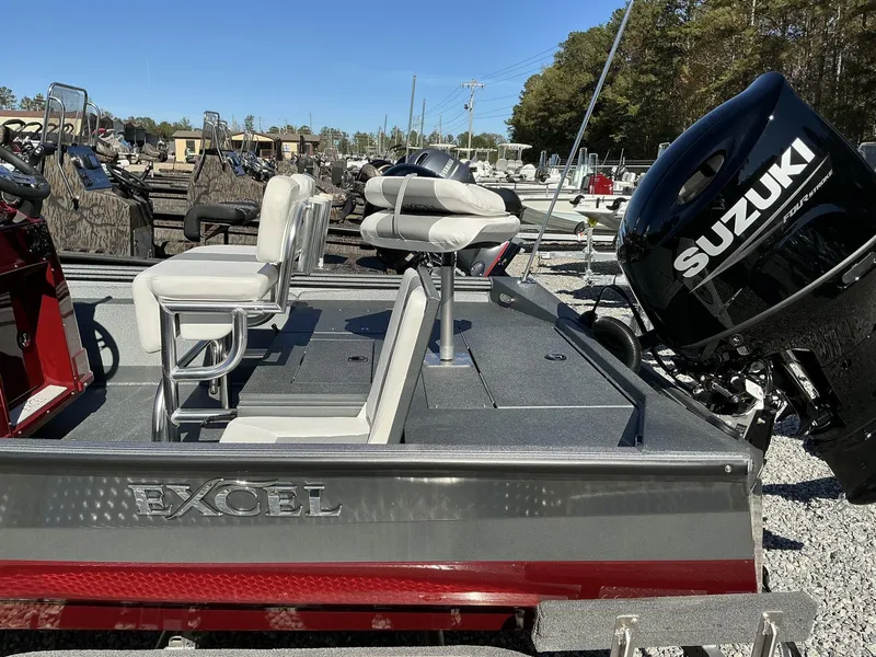 Slide: The Image of 2025 Excel Bay Pro 220 ELITE boat with Suzuki outboard motor, parked outdoors. - 10