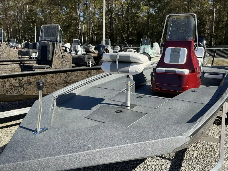Slide: The Image of 2025 Excel Bay Pro 220 ELITE boat with sleek design, parked outdoors. - 3