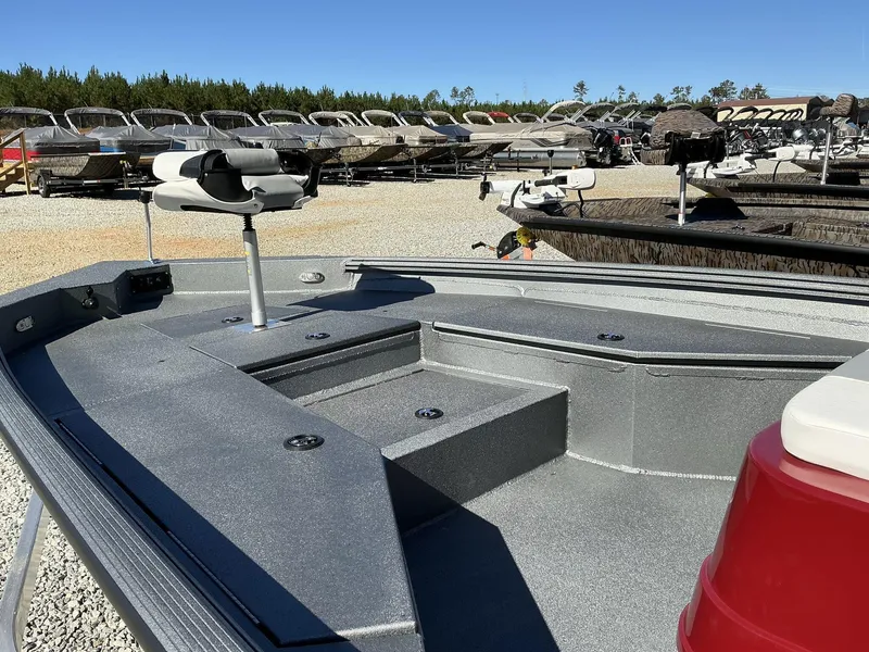 Slide: The Image of 2025 Excel Bay Pro 220 ELITE boat deck with seating, surrounded by other boats. - 9