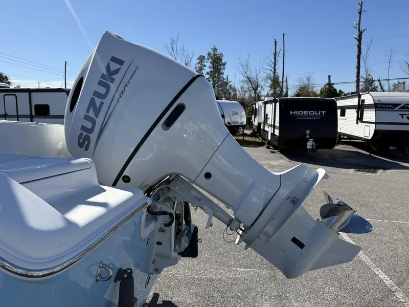 Slide: The Image of 2025 Sea Pro 222 boat with Suzuki outboard motor in a parking lot. - 6