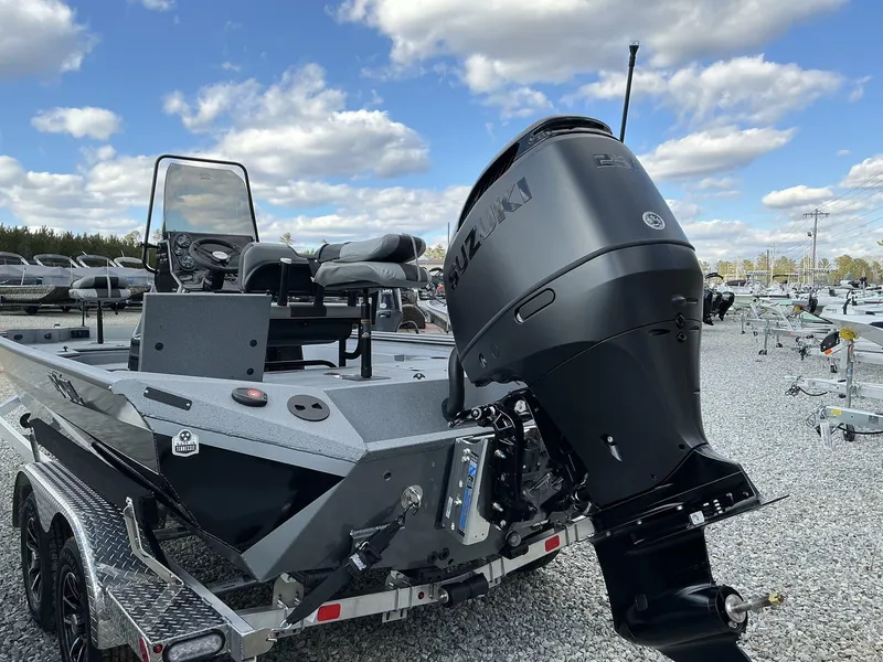 Slide: The Image of 2025 Excel New Bay Pro 230 SEADECK boat with Suzuki engine, displayed outdoors. - 3