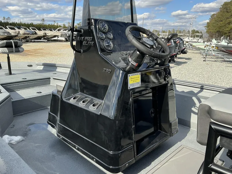 Slide: The Image of 2025 Excel New Bay Pro 230 SEADECK boat console, featuring steering wheel and controls. - 7