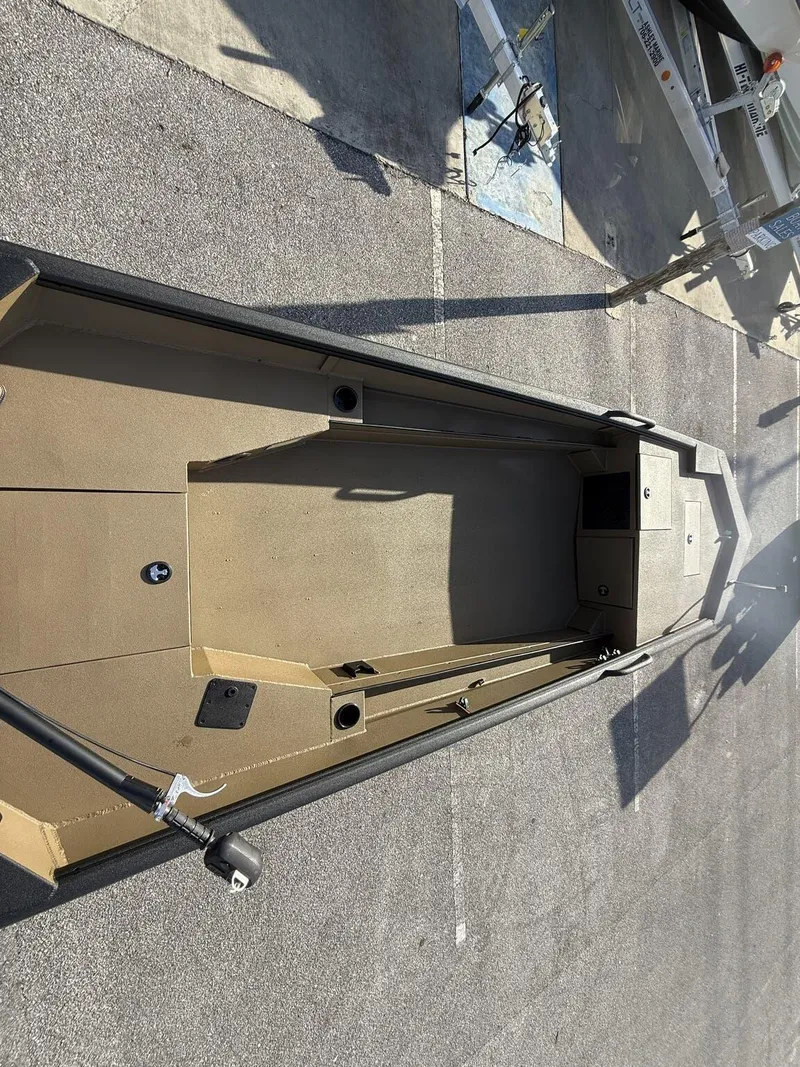 Slide: The Image of 2025 Excel 1754 Eclipse boat with Mud Buddy Mini 40, parked on pavement. - 6