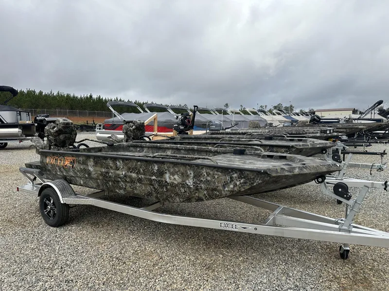 Slide: The Image of 2025 Excel Shallow Water F4 1754 F86 HDR5000 boat on trailer, camo design, outdoor display. - 1