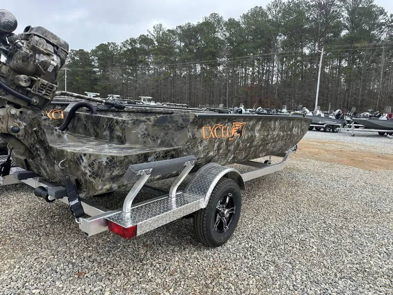 Slide: The Image of 2025 Excel Shallow Water F4 1754 F86 HDR5000 boat on trailer, camo design, forest background. - 6