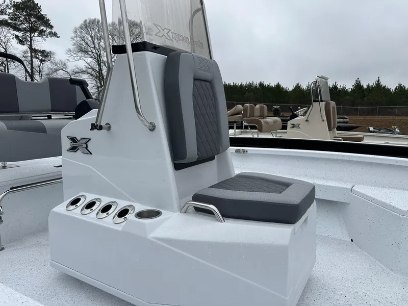 Slide: The Image of 2025 Xpress Hyper-Lift Series H22B boat interior with gray seating and console. - 12