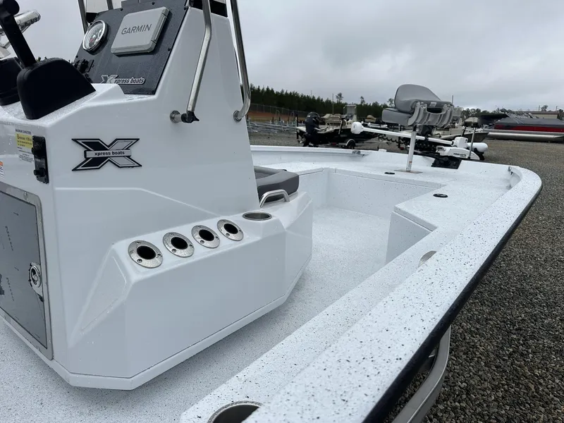 Slide: The Image of 2025 Xpress Hyper-Lift Series H22B boat with Garmin system, white interior, and fishing rod holders. - 14