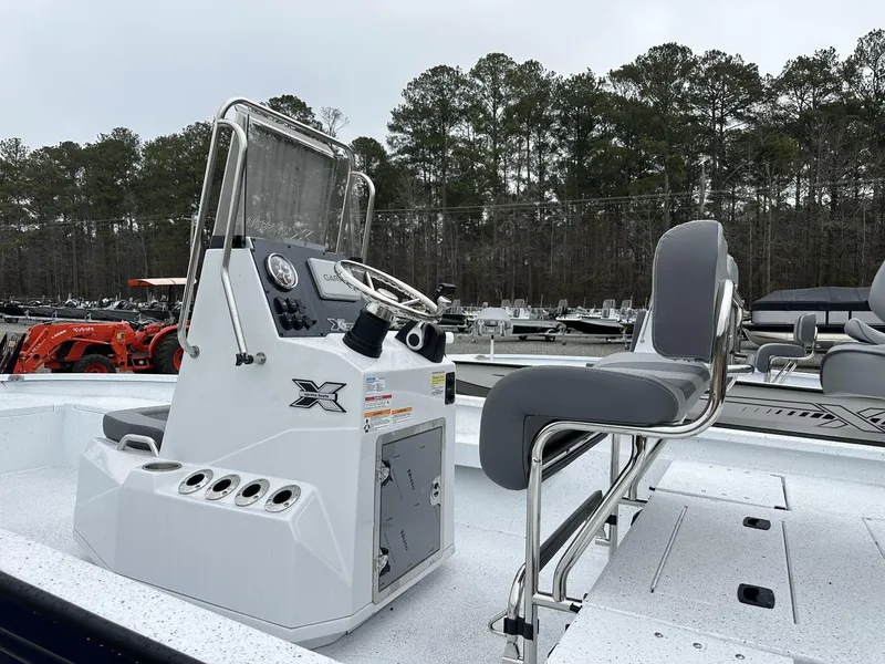 Slide: The Image of 2025 Xpress Hyper-Lift Series H22B boat with console and seating, outdoors. - 5
