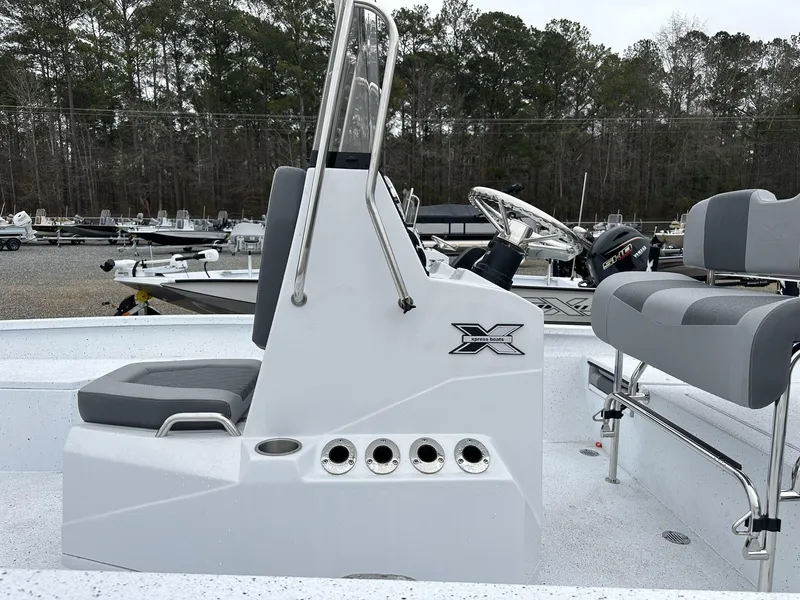 Slide: The Image of 2025 Xpress Hyper-Lift Series H22B boat interior with steering console and seating. - 9