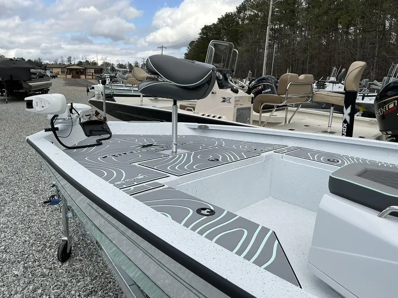 Slide: The Image of 2025 Xpress Hyper-Lift Series H20B boat with new console, parked on gravel lot. - 5