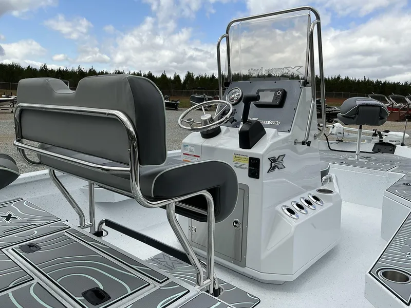 Slide: The Image of 2025 Xpress Hyper-Lift Series H20B boat console with seating, steering, and controls. - 8