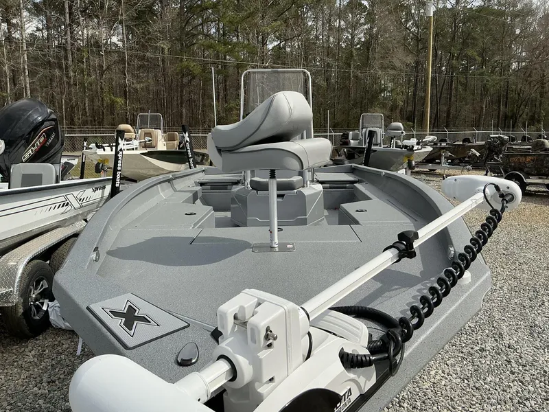 Slide: The Image of 2025 Xpress Hyper-Lift Series H22B boat with trolling motor, parked on gravel. - 3