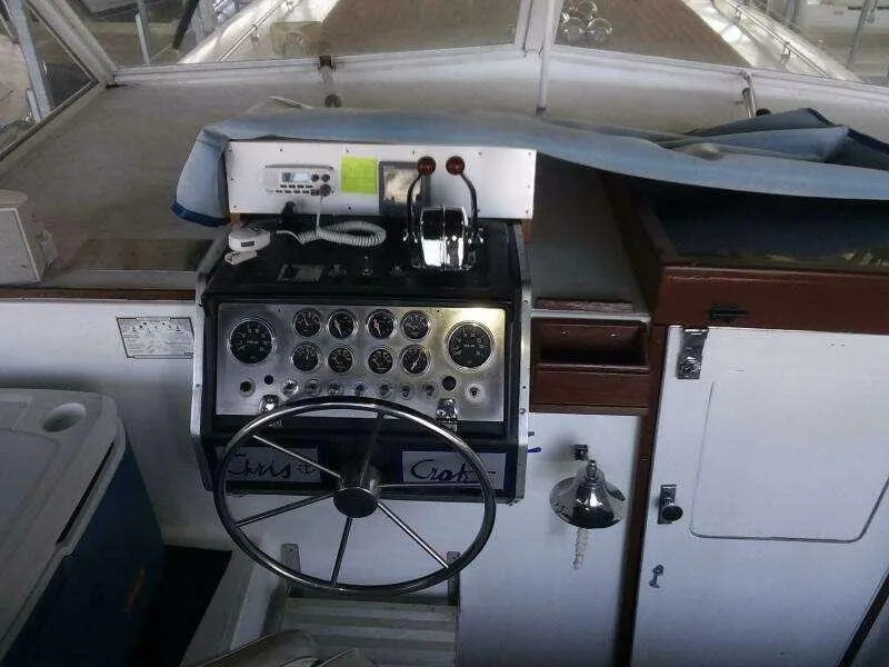 Slide: The Image of 1979 Chris-Craft 350 Catalina helm with gauges and controls, showcasing classic boat design. - 12