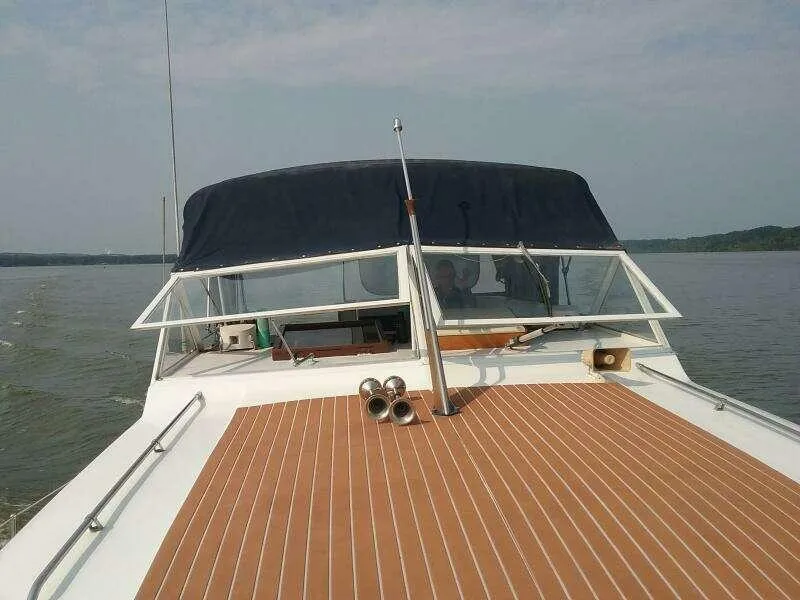 Slide: The Image of 1979 Chris-Craft 350 Catalina boat on calm water, featuring a sleek deck and canopy. - 3