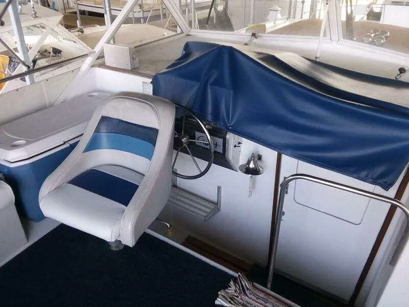 Slide: The Image of 1979 Chris-Craft 350 Catalina helm with blue seat and covered controls. - 6