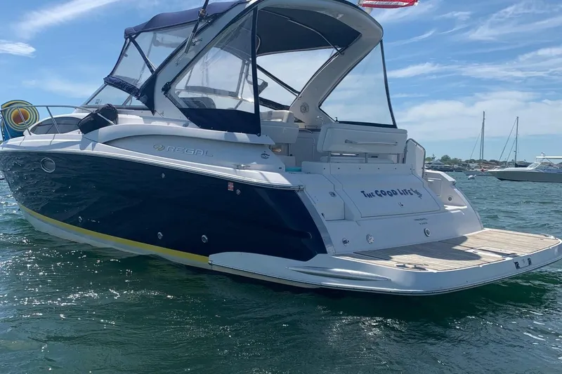 Slide: The Image of 2006 Regal 3360 Window Express boat on water, featuring sleek design and spacious deck. - 1