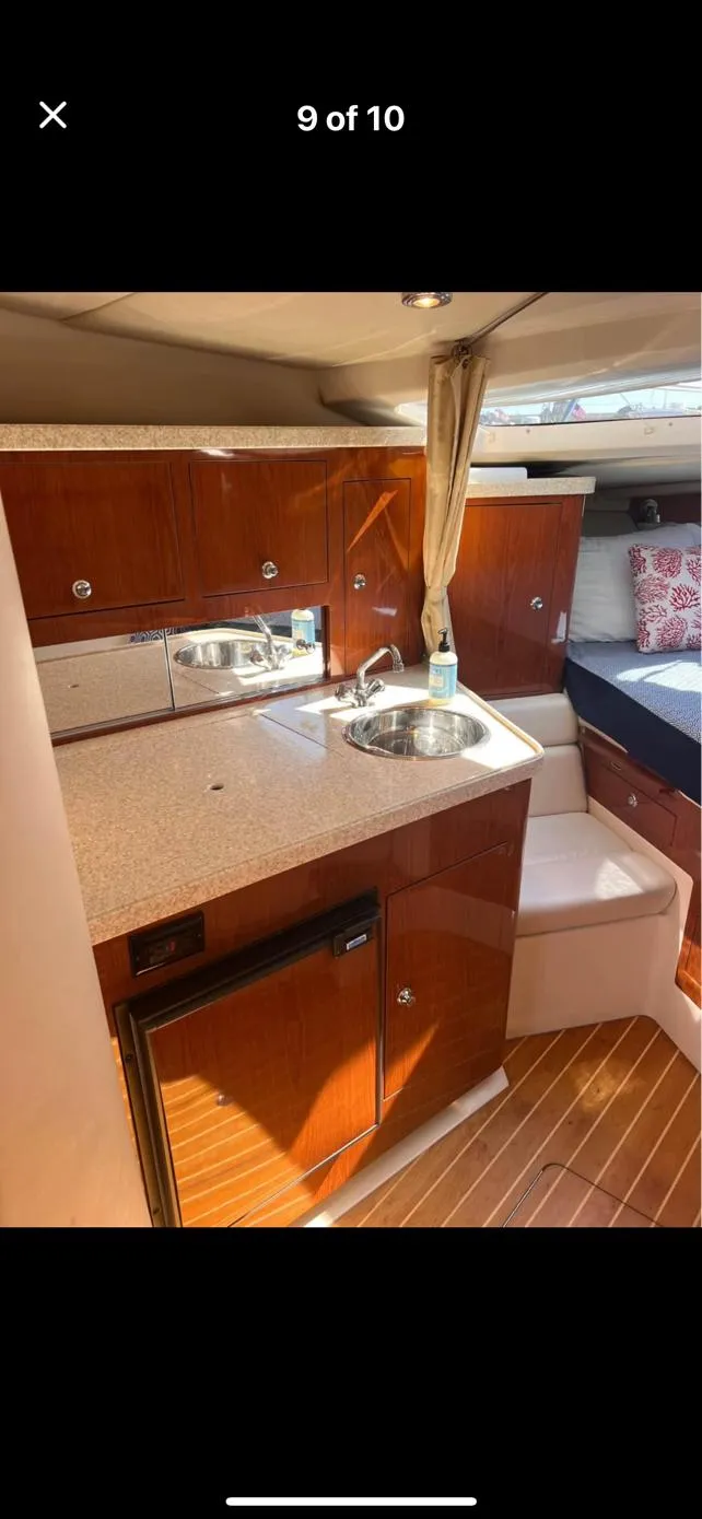 Slide: The Image of 2006 Regal 3360 Window Express yacht interior with kitchenette and bed. - 11