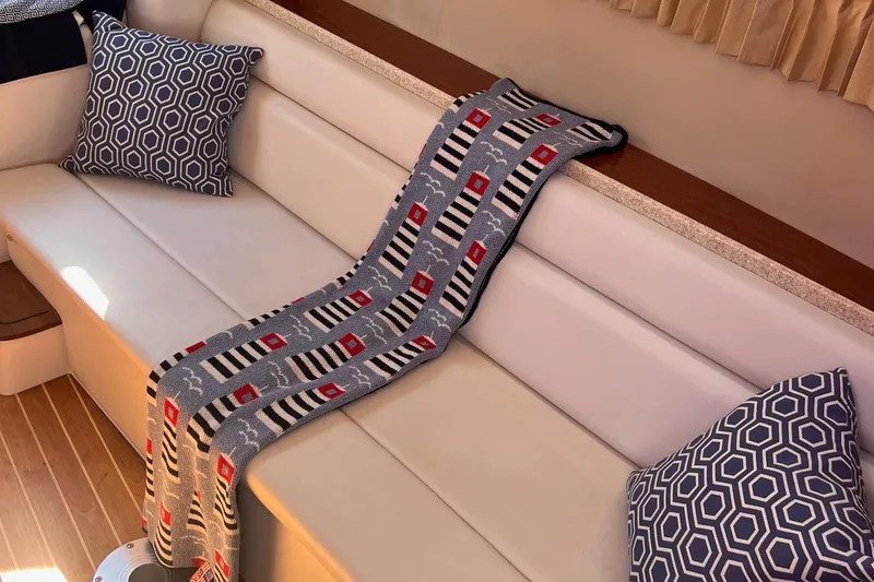 Slide: The Image of Interior of 2006 Regal 3360 Window Express with decorative pillows and a patterned throw. - 13