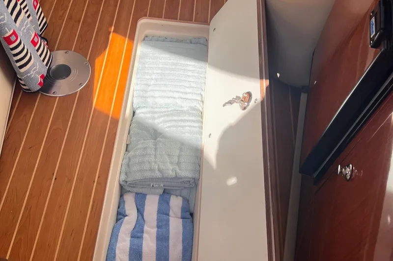 Slide: The Image of 2006 Regal 3360 Window Express interior with wooden flooring and storage compartment. - 17