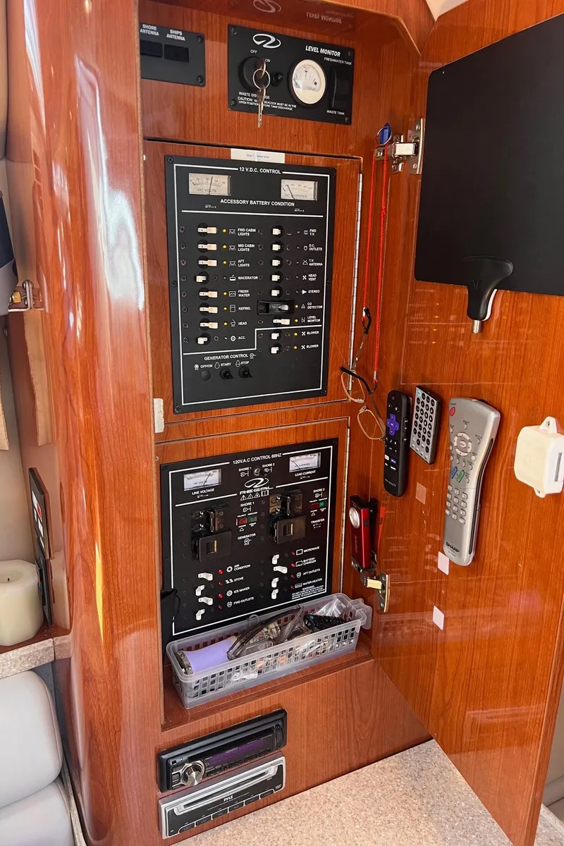 Slide: The Image of 2006 Regal 3360 Window Express control panel with switches and remote controls. - 19