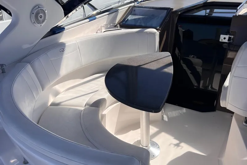 Slide: The Image of 2006 Regal 3360 Window Express boat interior with curved seating and table. - 27