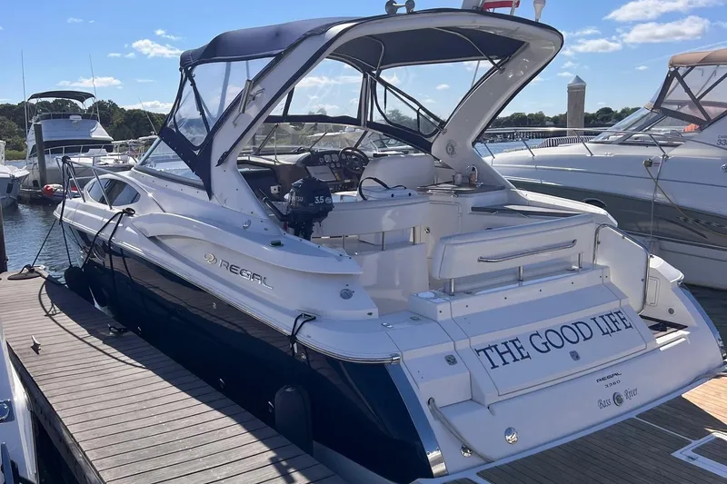 Slide: The Image of 2006 Regal 3360 Window Express boat docked, featuring "The Good Life" on the stern. - 3