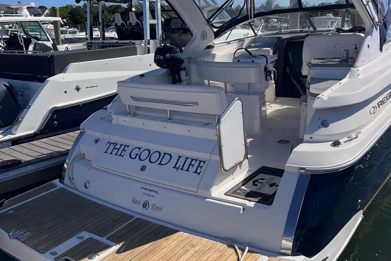 Slide: The Image of 2006 Regal 3360 Window Express boat named "The Good Life" docked at a marina. - 4