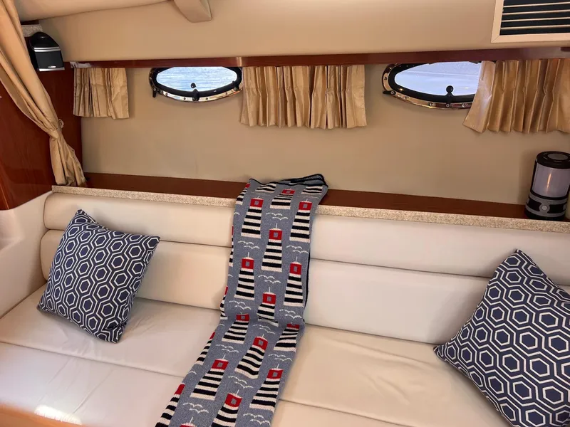 Slide: The Image of Interior of 2006 Regal 3360 Window Express with cushions and nautical decor. - 5