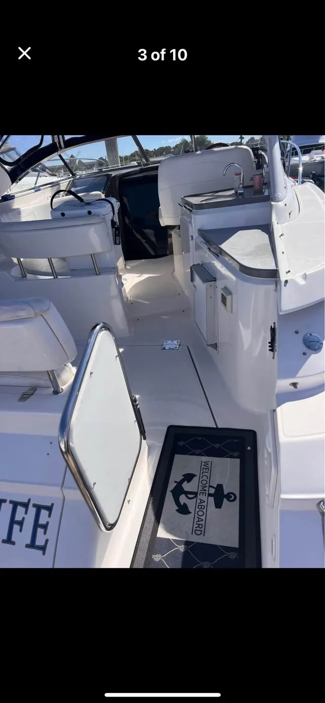 Slide: The Image of 2006 Regal 3360 Window Express boat interior with seating and helm area. - 8