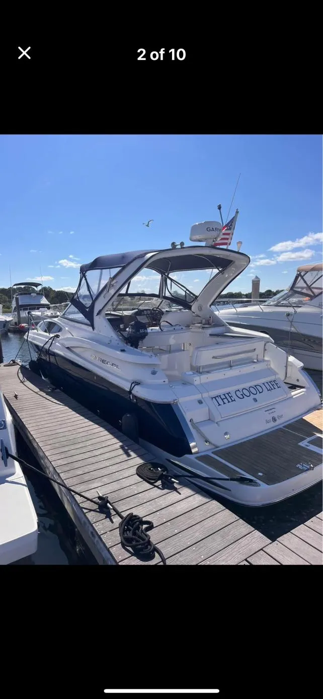 Slide: The Image of 2006 Regal 3360 Window Express boat docked at marina under clear sky. - 9