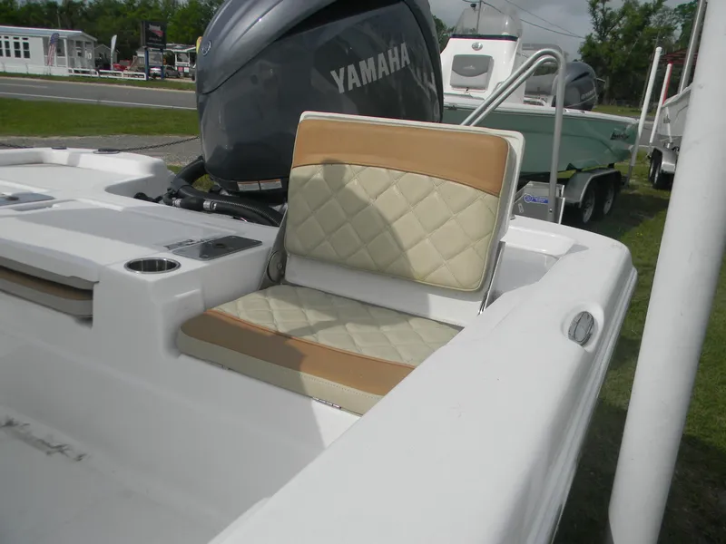 Slide: The Image of 2025 NauticStar 214 Shallow Bay boat with Yamaha engine, featuring cushioned seating. - 3