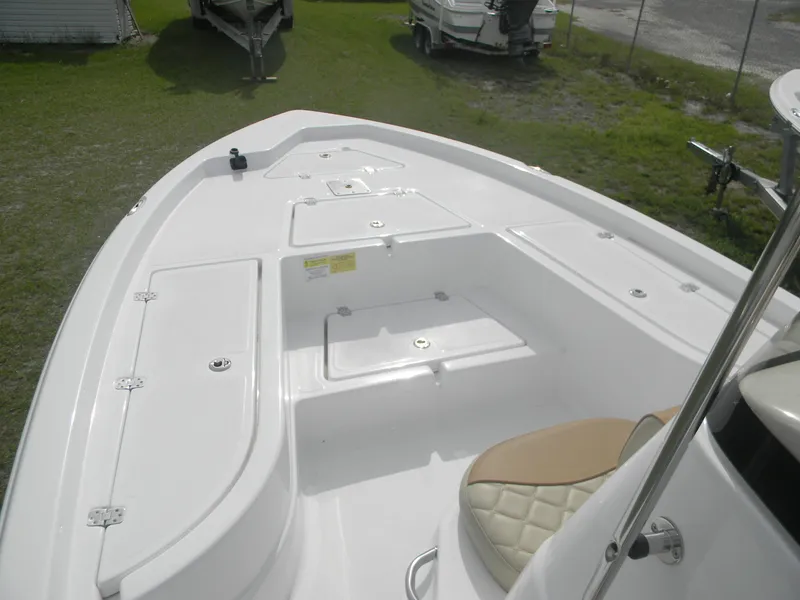 Slide: The Image of 2025 NauticStar 214 Shallow Bay boat deck with storage compartments and seating. - 4