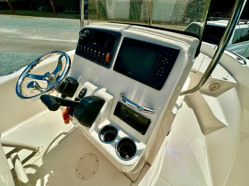 Slide: The Image of 2016 Grady-White 191 Coastal Explorer boat console with steering wheel and controls. - 10