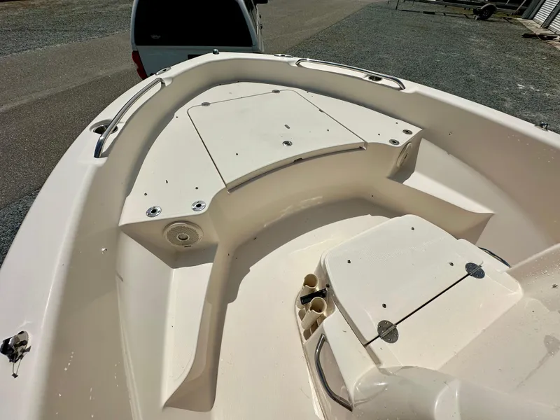 Slide: The Image of 2016 Grady-White 191 Coastal Explorer boat deck, featuring storage compartments and seating area. - 11