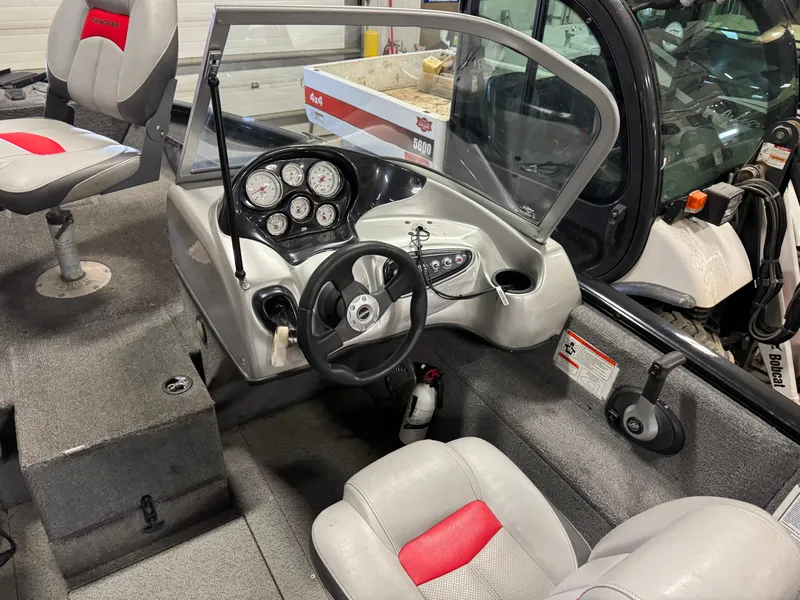 Slide: The Image of 2014 Tracker Pro Guide V-175 WT boat interior with steering wheel and dashboard controls. - 11