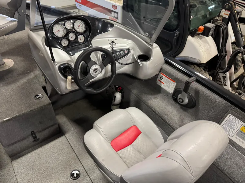 Slide: The Image of 2014 Tracker Pro Guide V-175 WT boat interior with steering wheel and dashboard controls. - 12