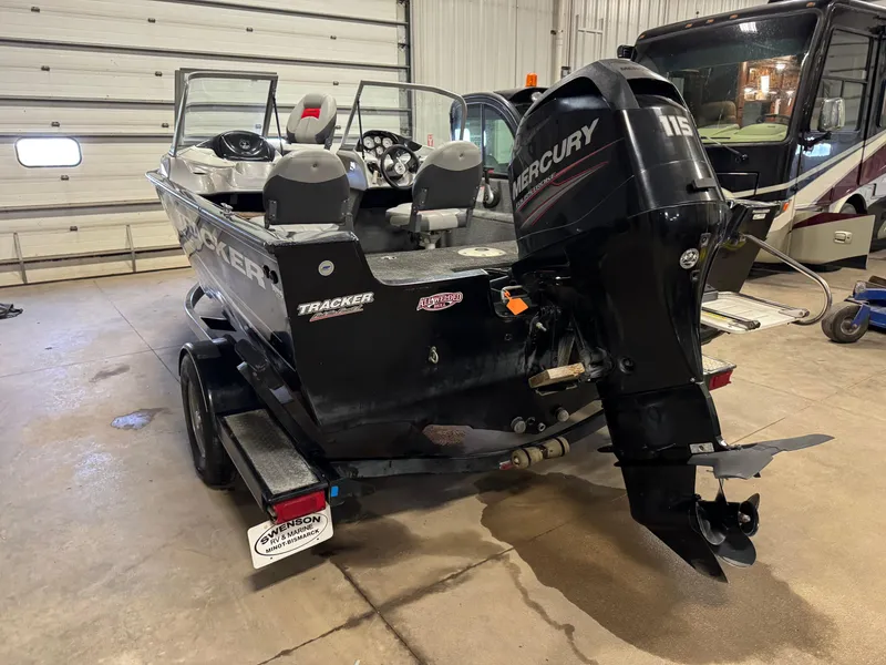 Slide: The Image of 2014 Tracker Pro Guide V-175 WT boat with Mercury 115 engine in garage. - 3