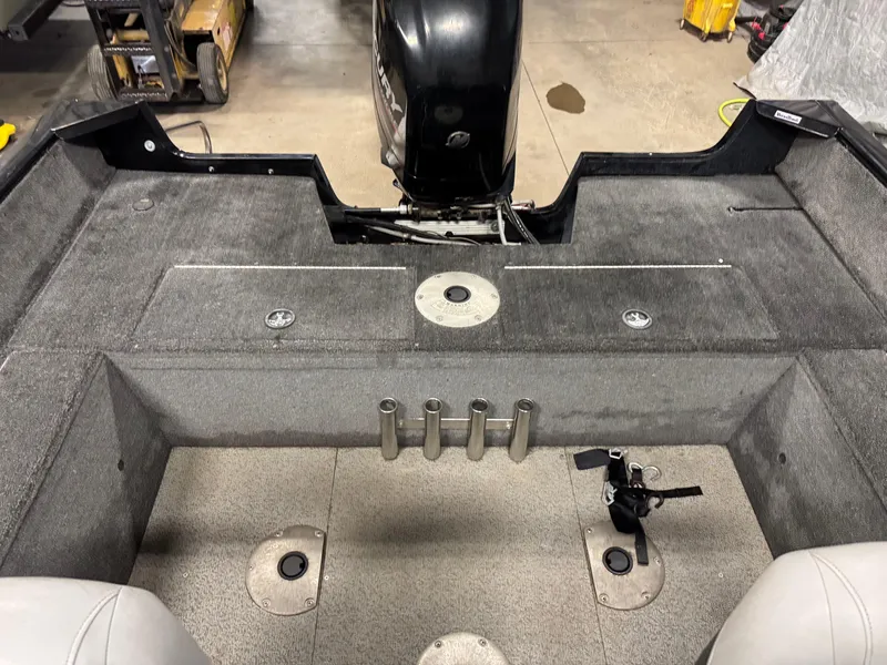 Slide: The Image of 2014 Tracker Pro Guide V-175 WT boat interior with motor and rod holders. - 8