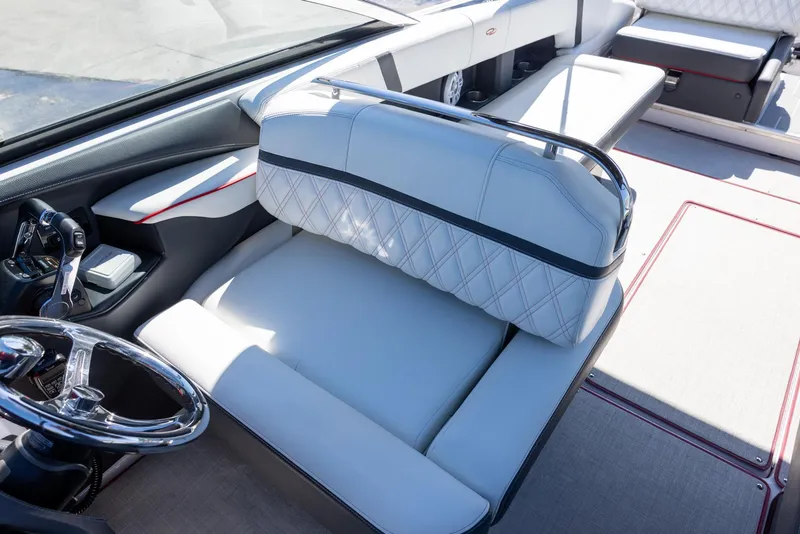 Slide: The Image of 2020 Regal 29 OBX boat interior with luxurious seating and steering wheel. - 11