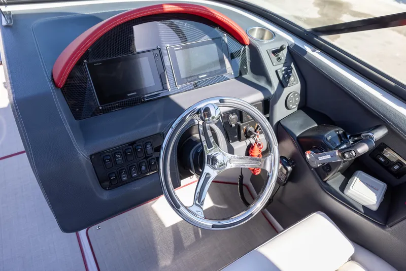 Slide: The Image of 2020 Regal 29 OBX boat dashboard with steering wheel and control panel. - 12