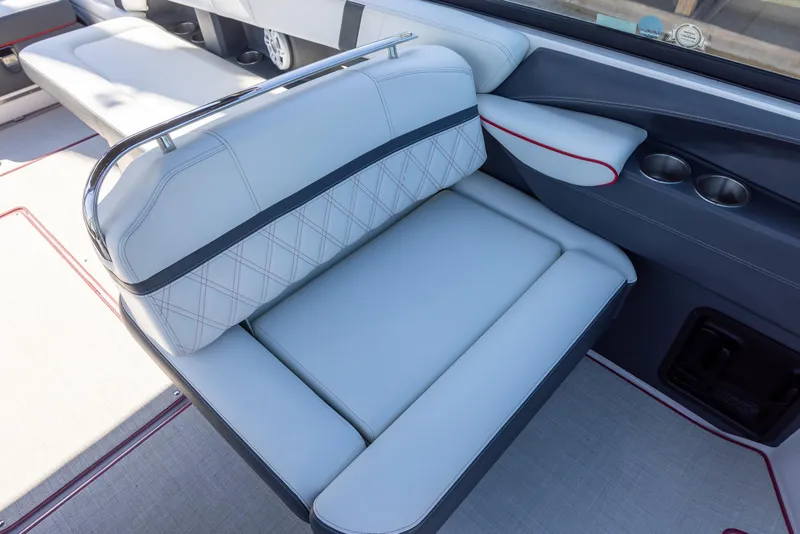 Slide: The Image of 2020 Regal 29 OBX boat interior with luxurious seating and cup holders. - 13