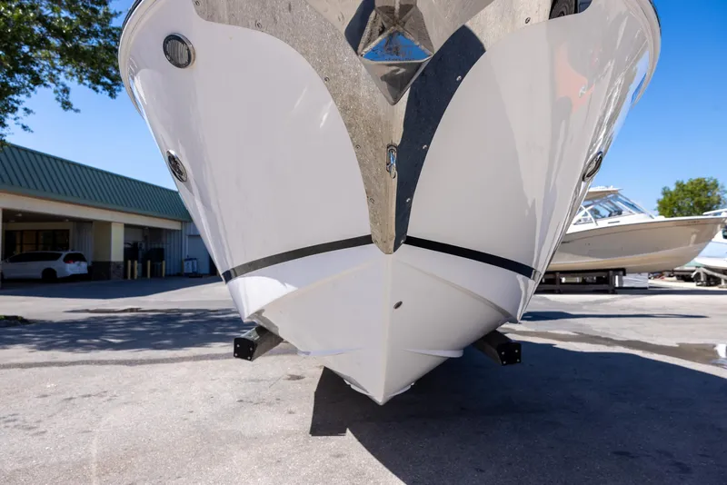 Slide: The Image of 2020 Regal 29 OBX boat front view in a marina setting. - 2
