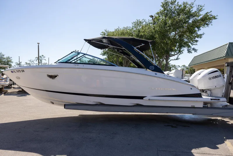Slide: The Image of 2020 Regal 29 OBX boat on trailer, side view, outdoors. - 4