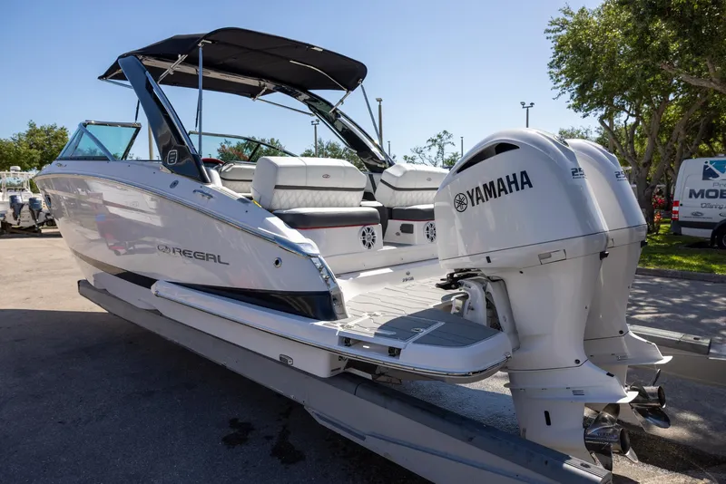 Slide: The Image of 2020 Regal 29 OBX boat with Yamaha engines, docked outdoors. - 5