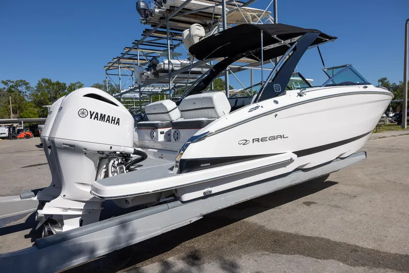 Slide: The Image of 2020 Regal 29 OBX boat with Yamaha outboard engine, parked outdoors. - 6