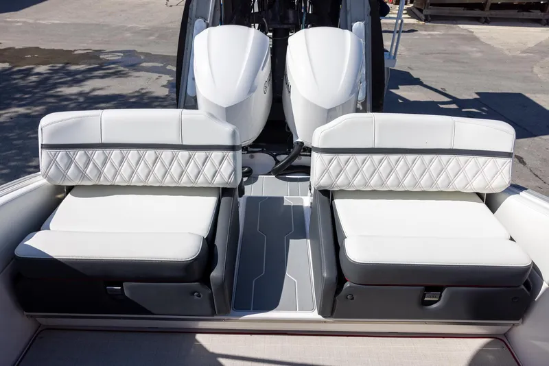 Slide: The Image of 2020 Regal 29 OBX boat with white cushioned seating and dual outboard engines. - 8