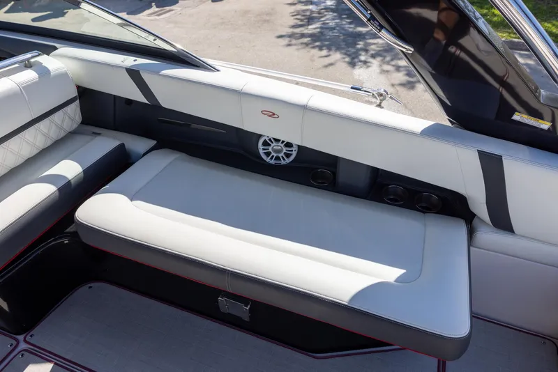 Slide: The Image of 2020 Regal 29 OBX boat interior with white cushioned seating and speaker. - 9