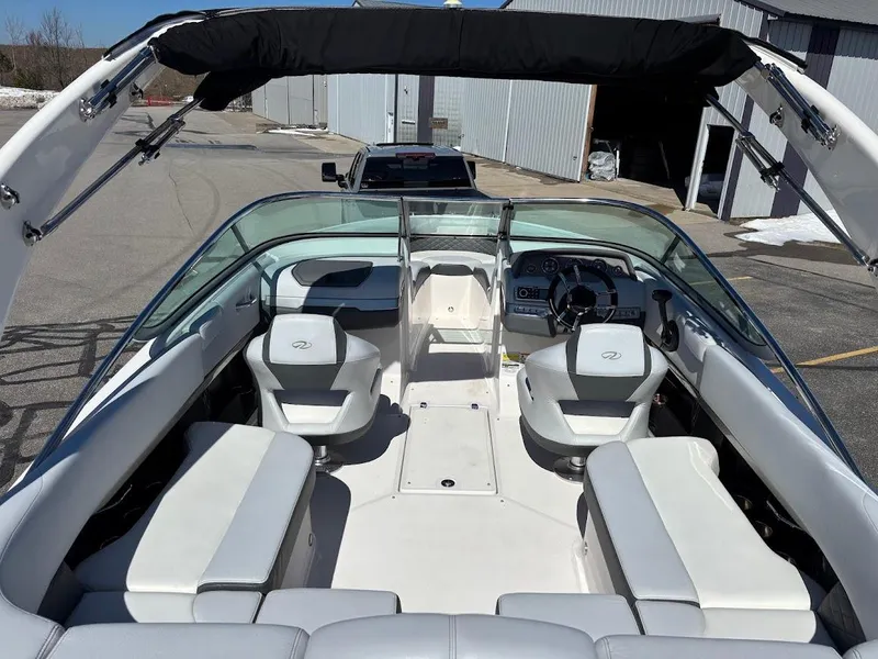 Slide: The Image of 2013 Regal 2300 Bowrider boat interior with seating and steering wheel. - 10